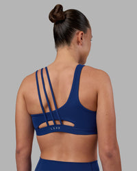 Woman wearing Galvanise Sports Bra 2.0 - Midnight Blue | Set:true | Angle:back | Model:Charlize | Size:S