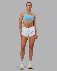 Woman wearing Galvanise Sports Bra 2.0 - Retro Blue | Model:Hannah | Size:S