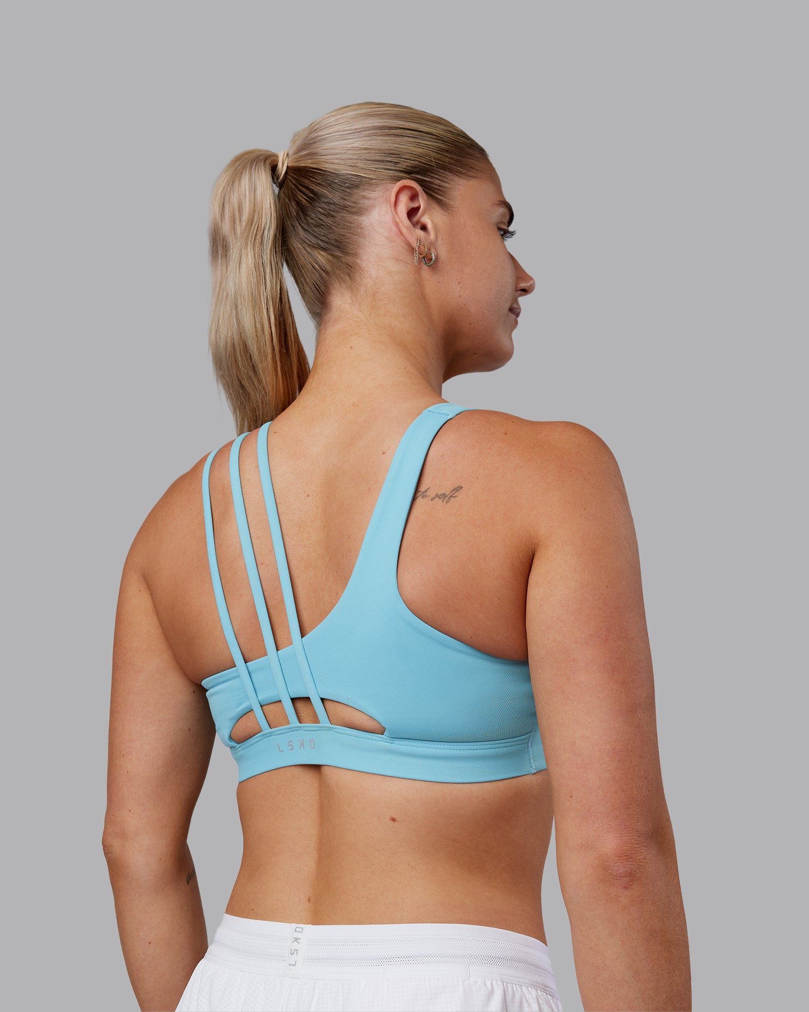 Woman wearing Galvanise Sports Bra 2.0 - Retro Blue | Model:Hannah | Size:S