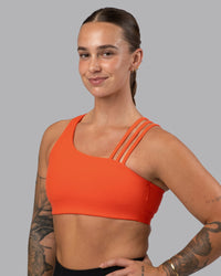 Woman wearing Galvanise Sports Bra 2.0 - Ultra Orange | Set:true | Angle:front | Model:Robyn | Size:S
