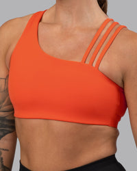 Woman wearing Galvanise Sports Bra 2.0 - Ultra Orange | Set:true | Angle:closeup | Model:Robyn | Size:S
