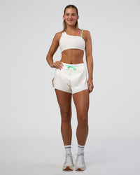 Woman wearing Galvanise Sports Bra 2.0 - Off White-Multi | Model:Amity | Size:S