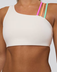 Woman wearing Galvanise Sports Bra 2.0 - Off White-Multi | Set:true | Angle:closeup | Model:Amity | Size:S
