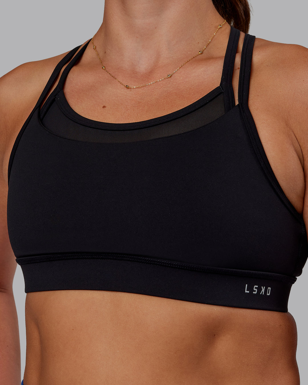 Woman wearing Genesis Layered Sports Bra - Black | Model:Phoebe | Size:S