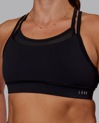 Woman wearing Genesis Layered Sports Bra - Black | Model:Phoebe | Size:S