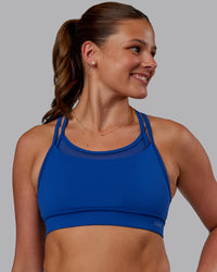 Woman wearing Genesis Layered Sports Bra - Blue Quartz | Model:Phoebe | Size:S