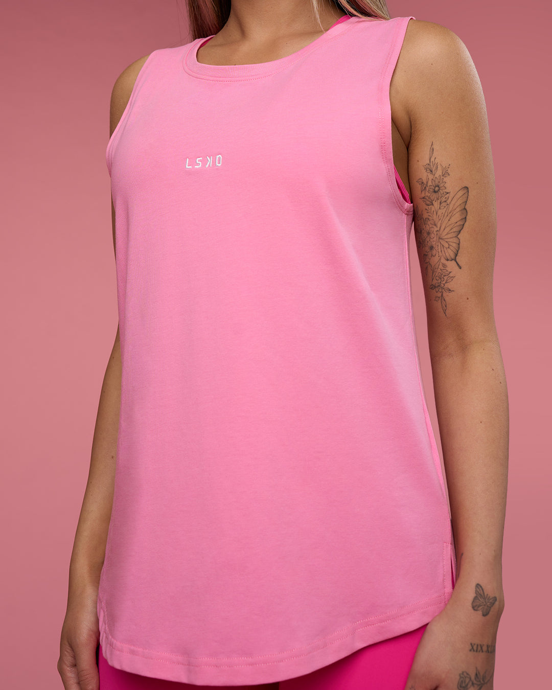 Woman wearing Go-To FLXCotton Longline Tank - Candy Pink-White | Model:Tianah | Size:S