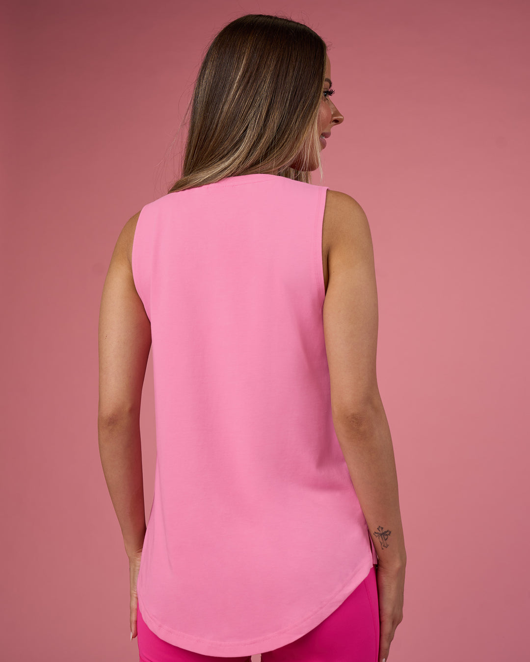 Woman wearing Go-To FLXCotton Longline Tank - Candy Pink-White | Model:Tianah | Size:S