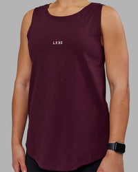 Woman wearing Go-To FLXCotton Longline Tank - Cherry Lacquer-White | Model:Keisha | Size:S