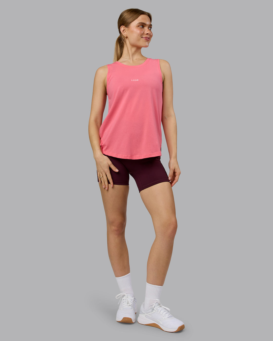 Woman wearing Go-To FLXCotton Longline Tank - Pink Lemonade-White | Model:Emilie | Size:S