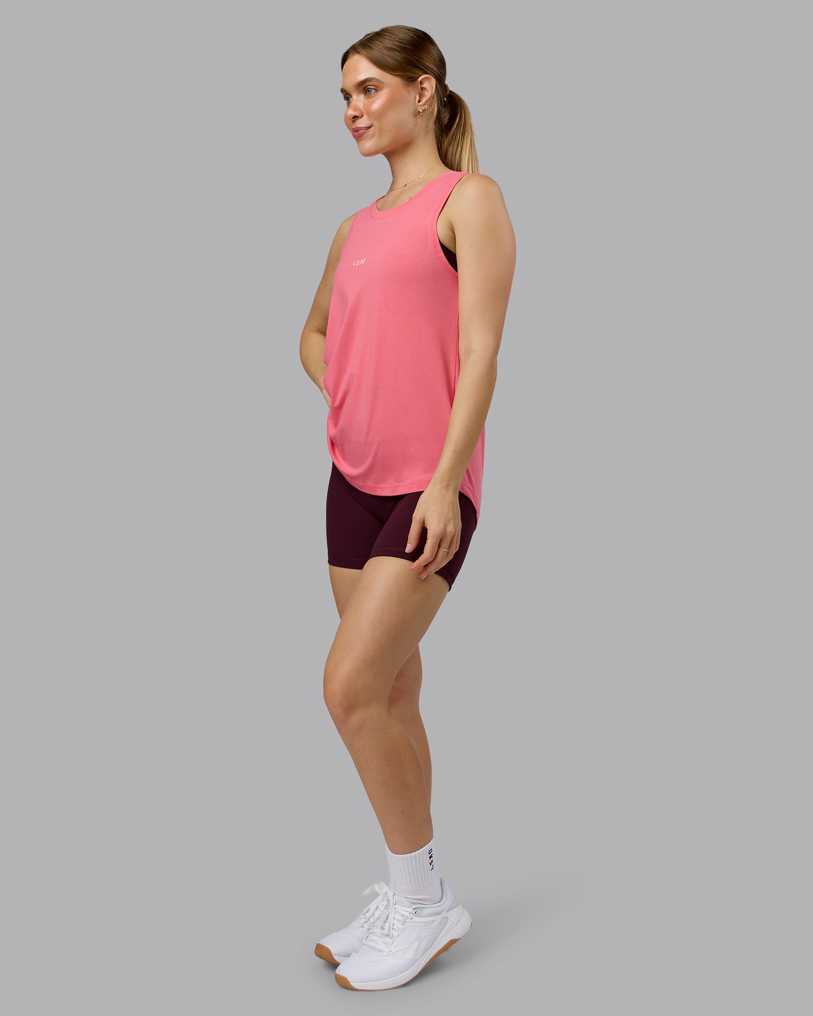 Woman wearing Go-To FLXCotton Longline Tank - Pink Lemonade-White | Model:Emilie | Size:S
