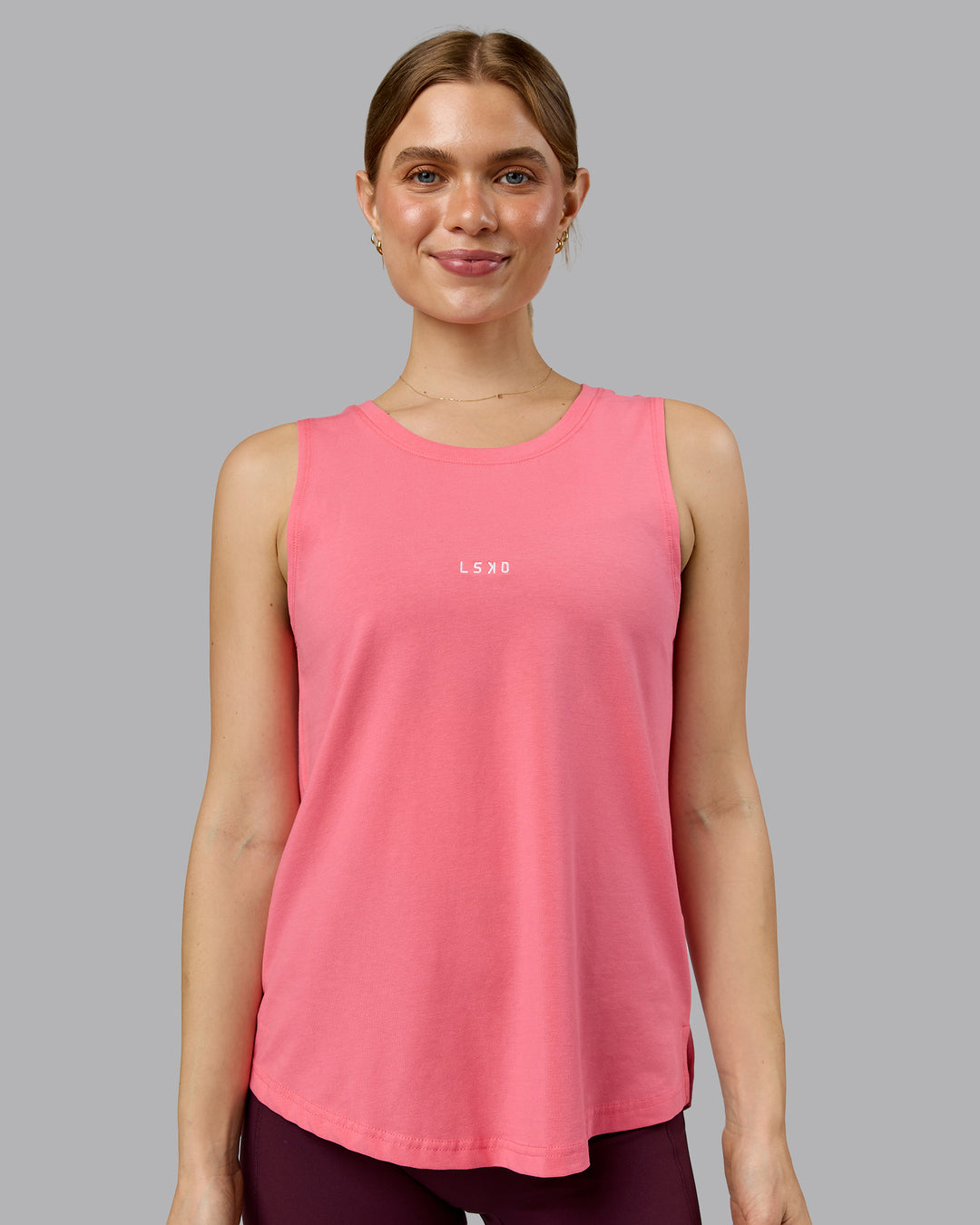 Woman wearing Go-To FLXCotton Longline Tank - Pink Lemonade-White | Model:Emilie | Size:S