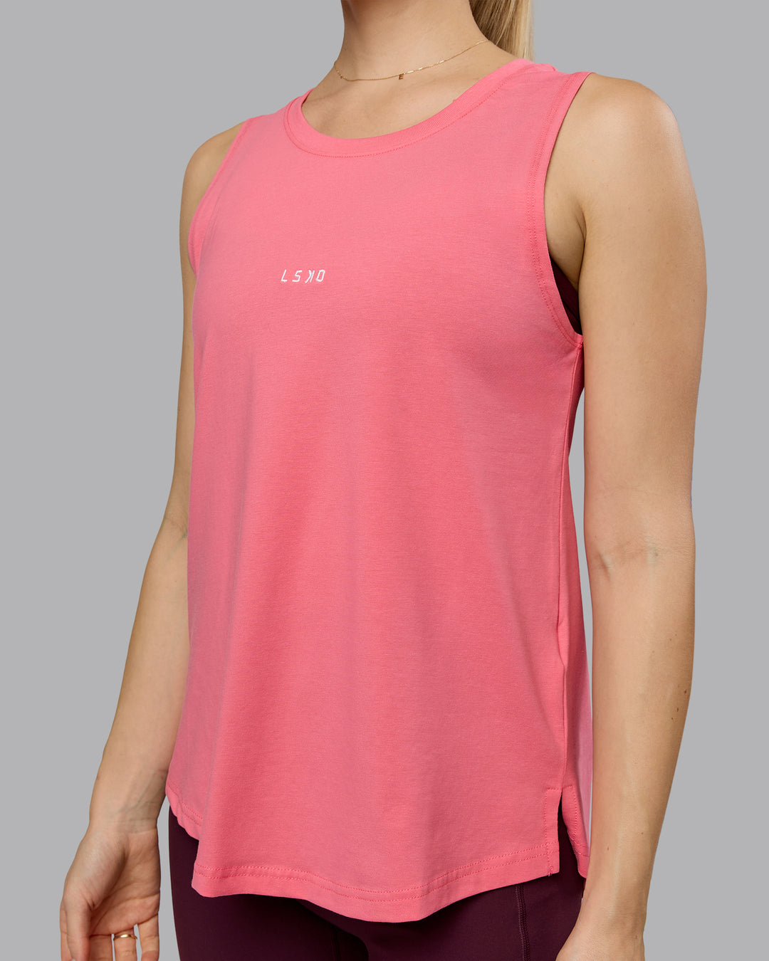 Woman wearing Go-To FLXCotton Longline Tank - Pink Lemonade-White | Model:Emilie | Size:S