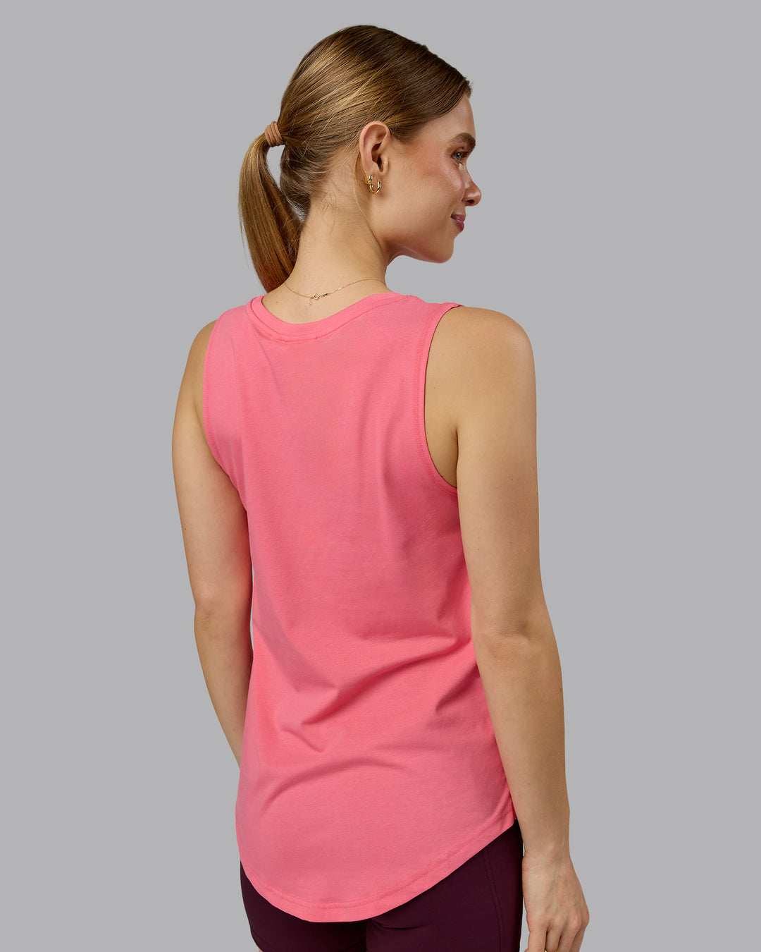 Woman wearing Go-To FLXCotton Longline Tank - Pink Lemonade-White | Model:Emilie | Size:S