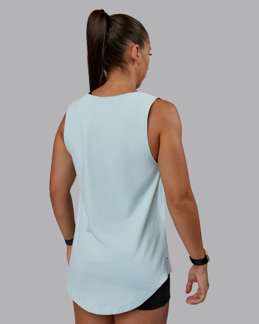 Woman wearing Go-To FLXCotton Longline Tank - Skyride-White | Size:S | Model:Tylah