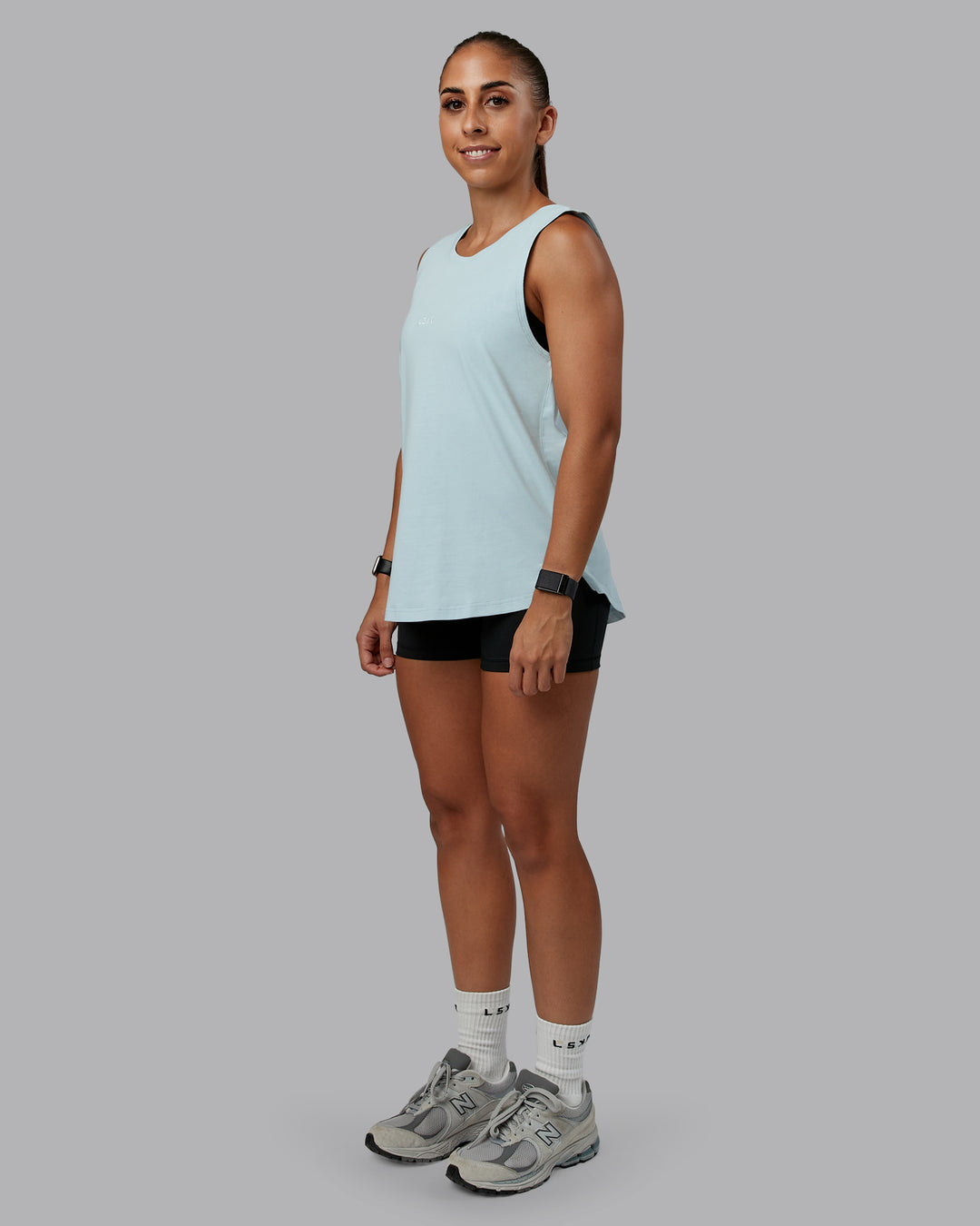 Woman wearing Go-To FLXCotton Longline Tank - Skyride-White | Size:S | Model:Tylah
