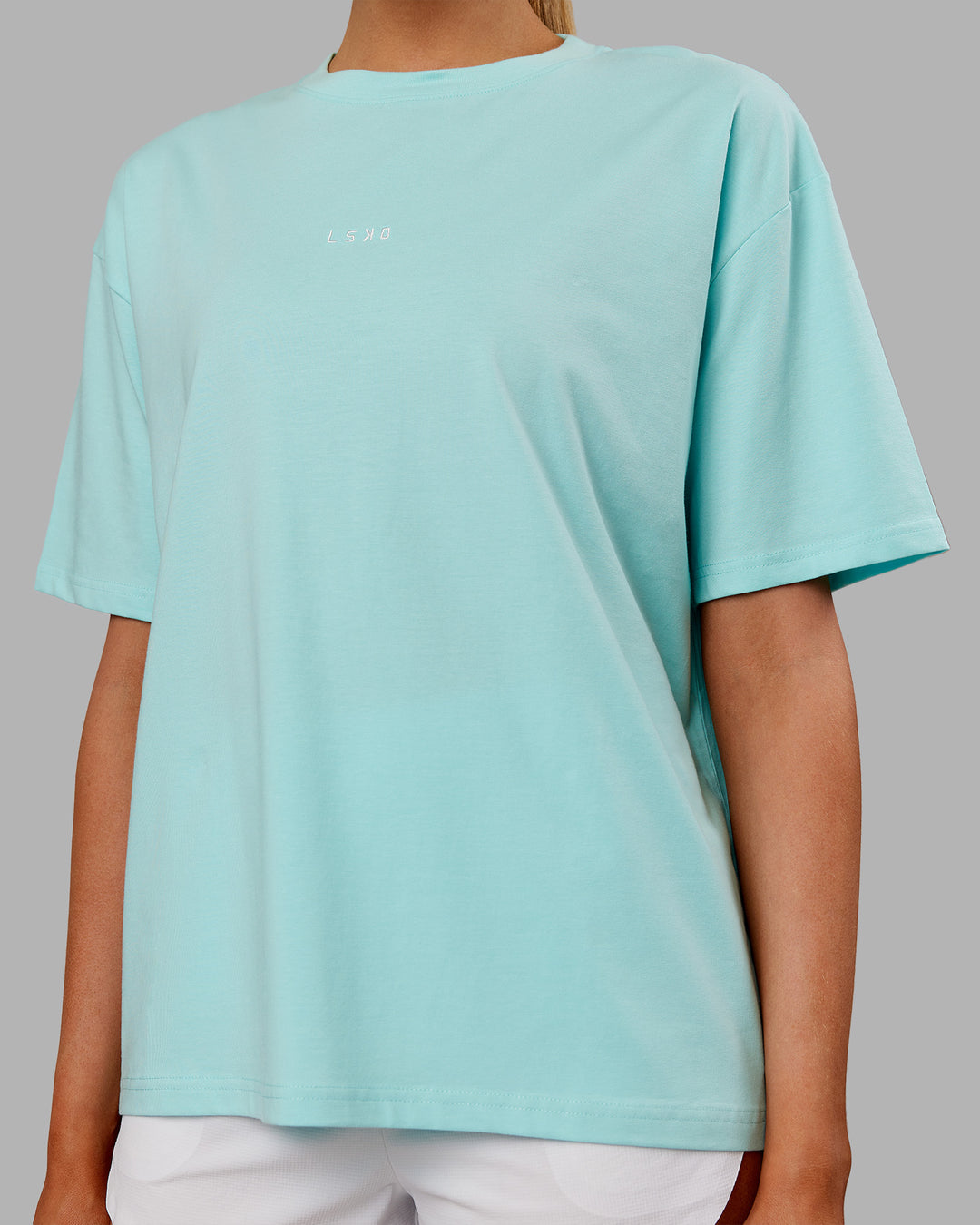 Woman wearing Go-To FLXCotton Oversized Tee - Island Paradise-White | Model:Ella | Size:S