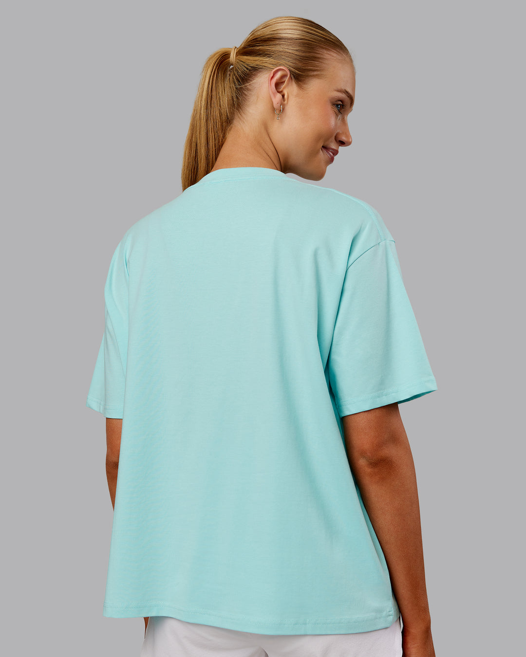 Woman wearing Go-To FLXCotton Oversized Tee - Island Paradise-White | Model:Ella | Size:S