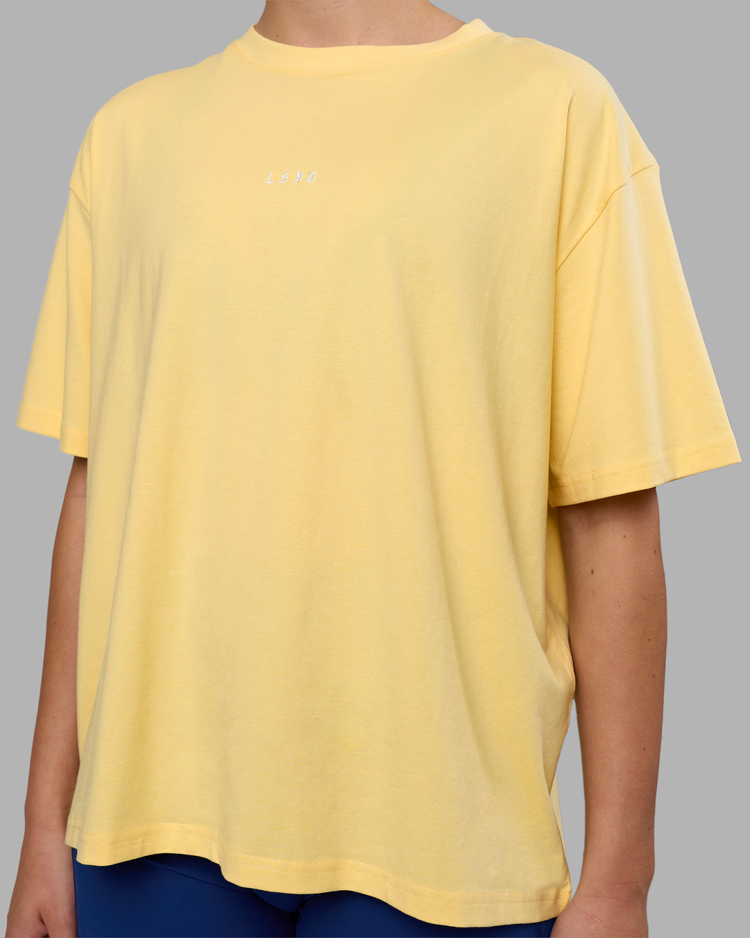 Woman wearing Go-To FLXCotton Oversized Tee - Lemon-White | Model:Charlize | Size:S