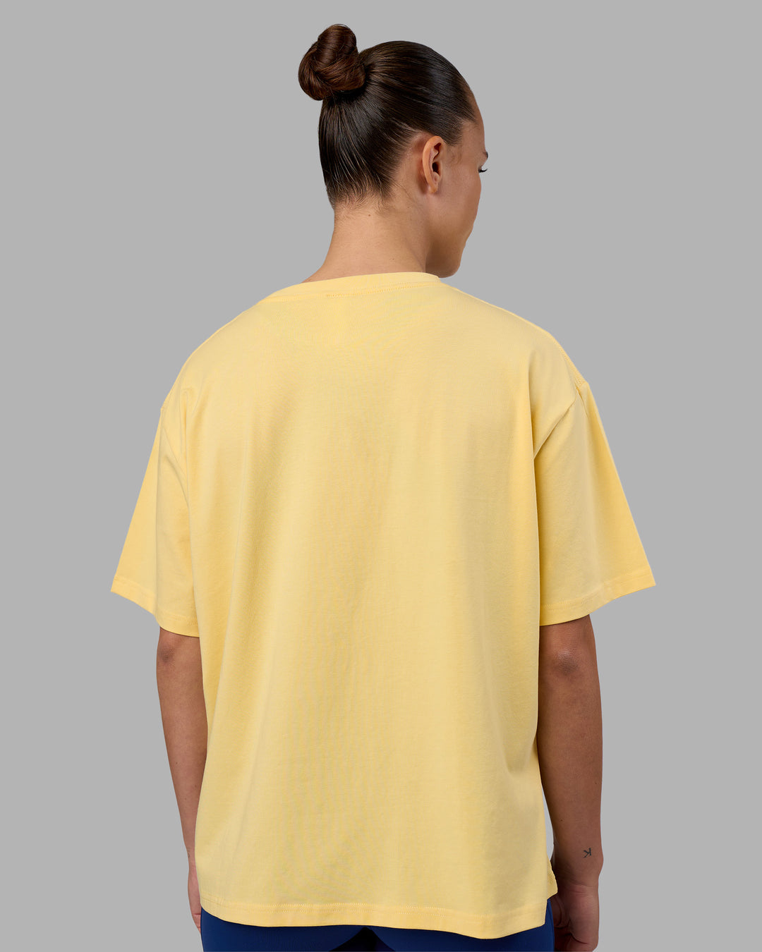 Woman wearing Go-To FLXCotton Oversized Tee - Lemon-White | Model:Charlize | Size:S