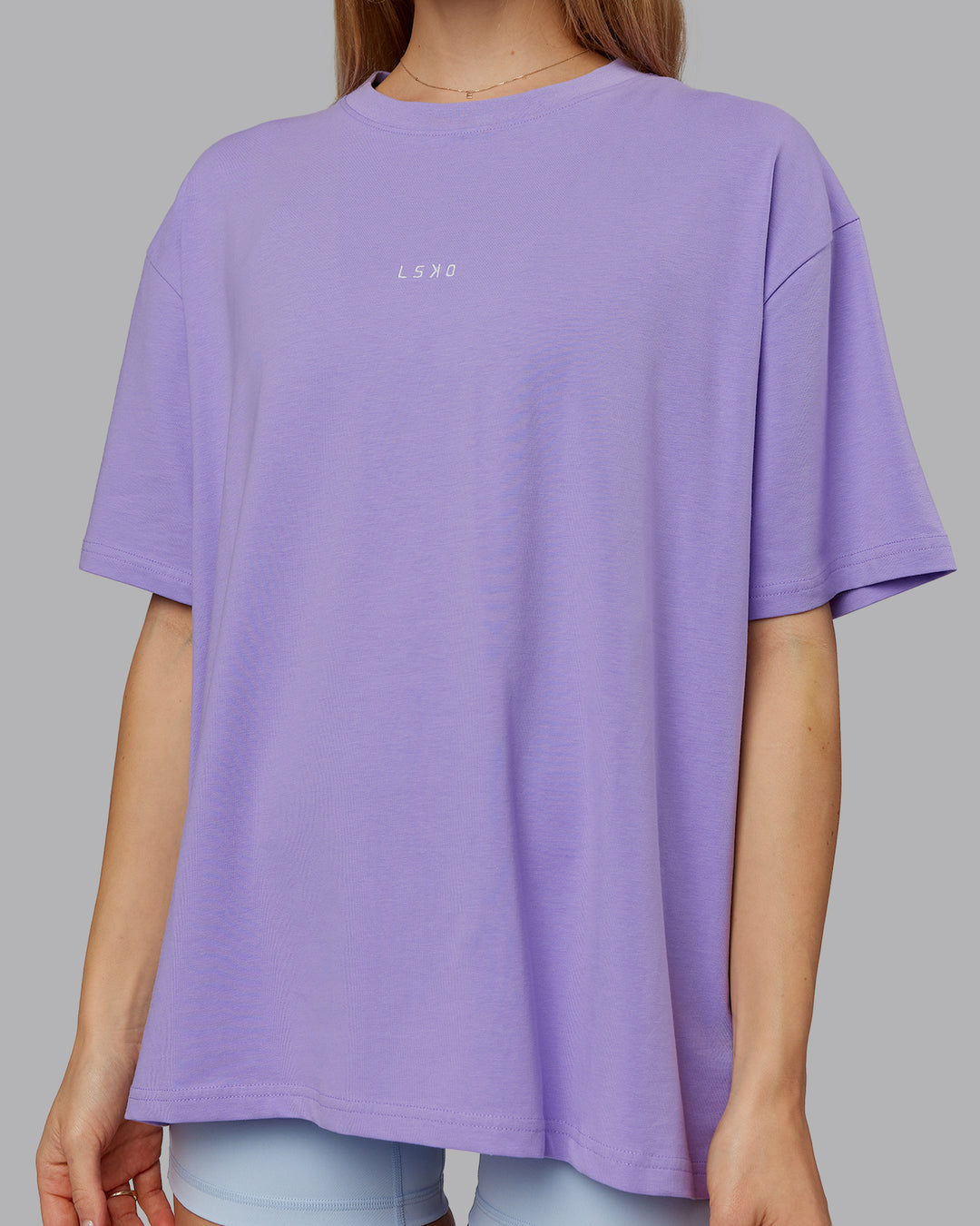 Woman wearing Go-To FLXCotton Oversized Tee - Violet Ray-White | Model:Emilie | Size:S