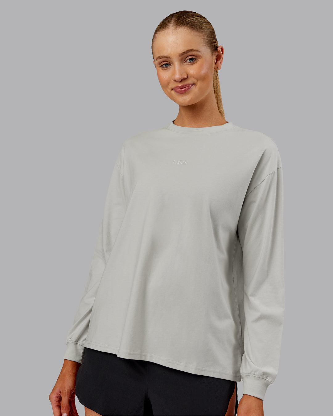 Woman wearing Go-To Long Sleeve FLXCotton Oversized Tee - Digital Mist-White | Model:Ella| Size:S