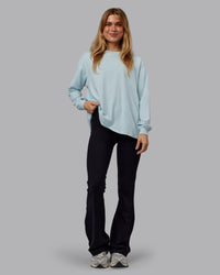 Woman wearing Go-To Long Sleeve FLXCotton Oversized Tee - Skyride-White | Model:Emilie | Size:S
