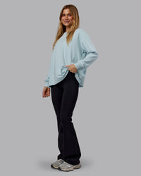 Woman wearing Go-To Long Sleeve FLXCotton Oversized Tee - Skyride-White | Model:Emilie | Size:S