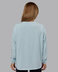 Woman wearing Go-To Long Sleeve FLXCotton Oversized Tee - Skyride-White | Model:Emilie | Size:S
