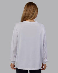 Woman wearing Go-To Long Sleeve FLXCotton Oversized Tee - White-Black | Model:Emilie | Size:S