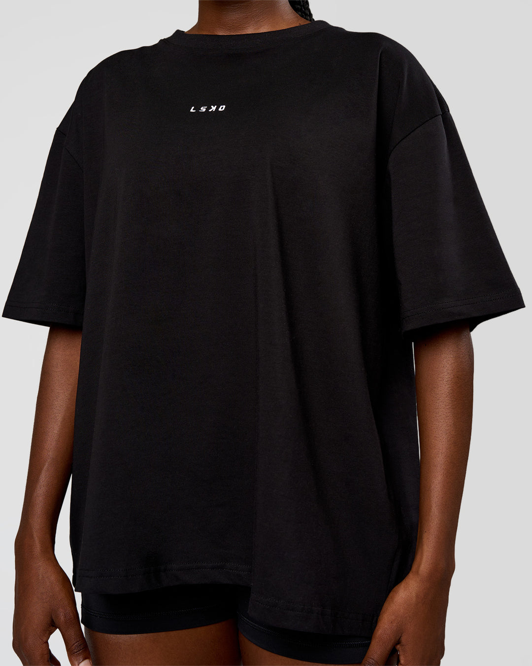 Woman wearing Go-To Run Club FLXCotton Oversized Tee - Black-Marshmallow | Model:Ellie | Size:S