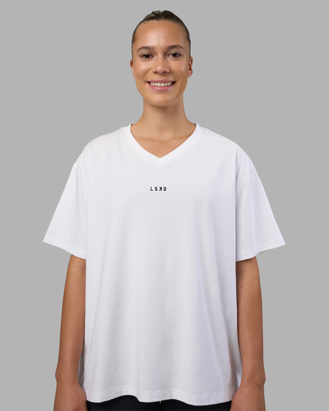Woman wearing Go-To V-Neck FLXCotton Oversized Tee - White-Black | Model:Charlize | Size:S