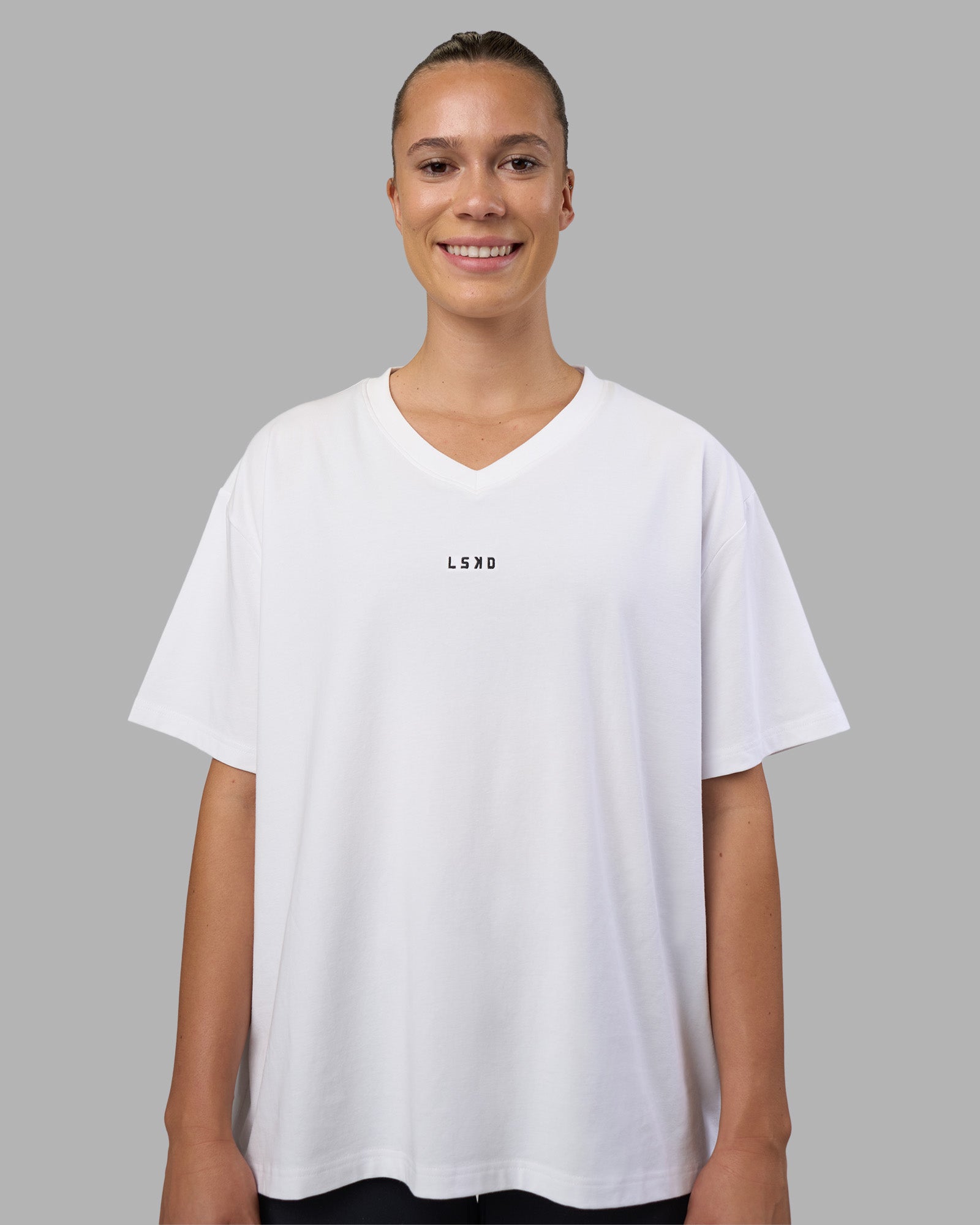 Woman wearing Go-To V-Neck FLXCotton Oversized Tee - White-Black | Model:Charlize | Size:S