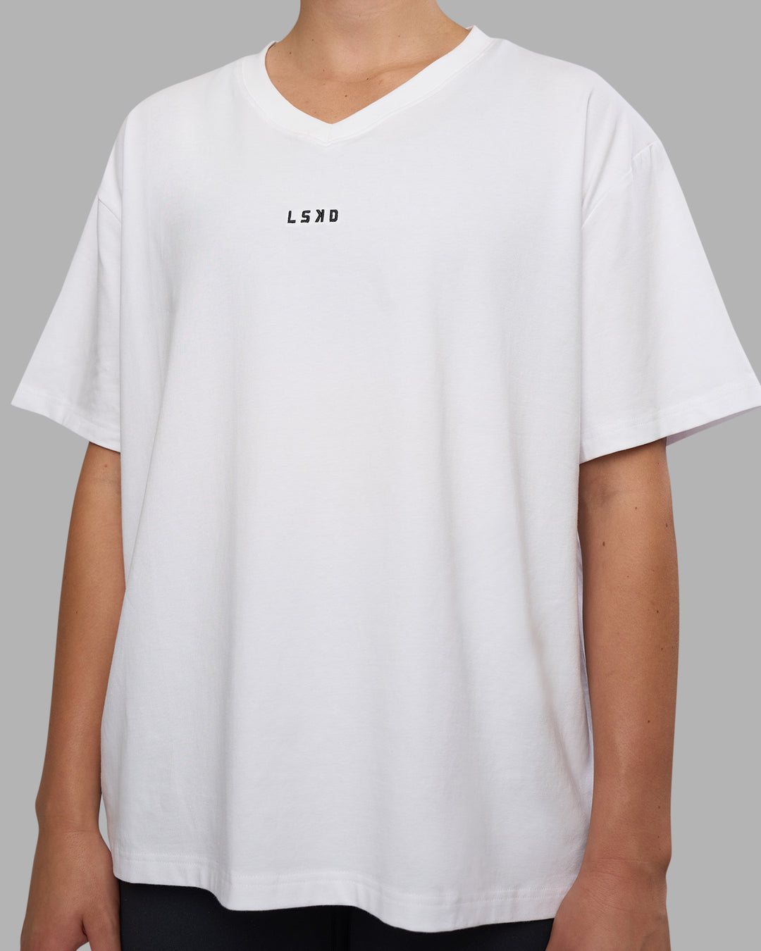 Woman wearing Go-To V-Neck FLXCotton Oversized Tee - White-Black | Model:Charlize | Size:S