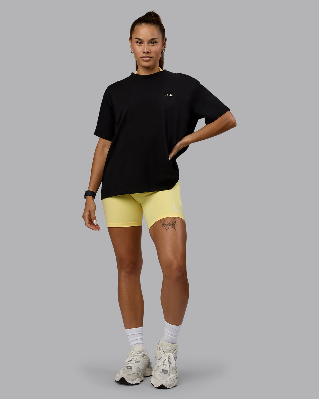 Woman wearing Go-To We Rise FLXCotton Oversized Tee - Black-Glacial Blue