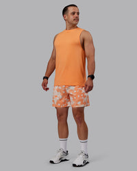 Man wearing Grand Slam 6" Shorts in Wildflower Cantaloupe | Size:S
