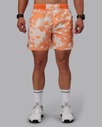 Man wearing Grand Slam 6" Shorts in Wildflower Cantaloupe | Size:S