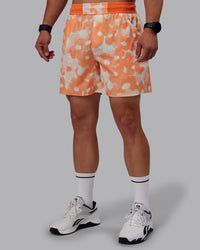  Man wearing Grand Slam 6" Shorts in Wildflower Cantaloupe | Size:S