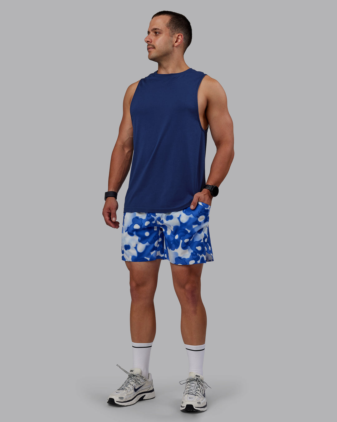 Man wearing Grand Slam 6" Shorts in Wildflower Midnight Blue | Size:S