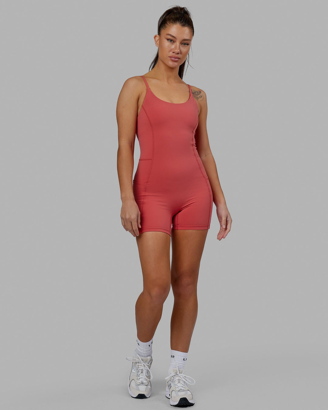 Woman wearing Helix Active Bodysuit - Mineral Red