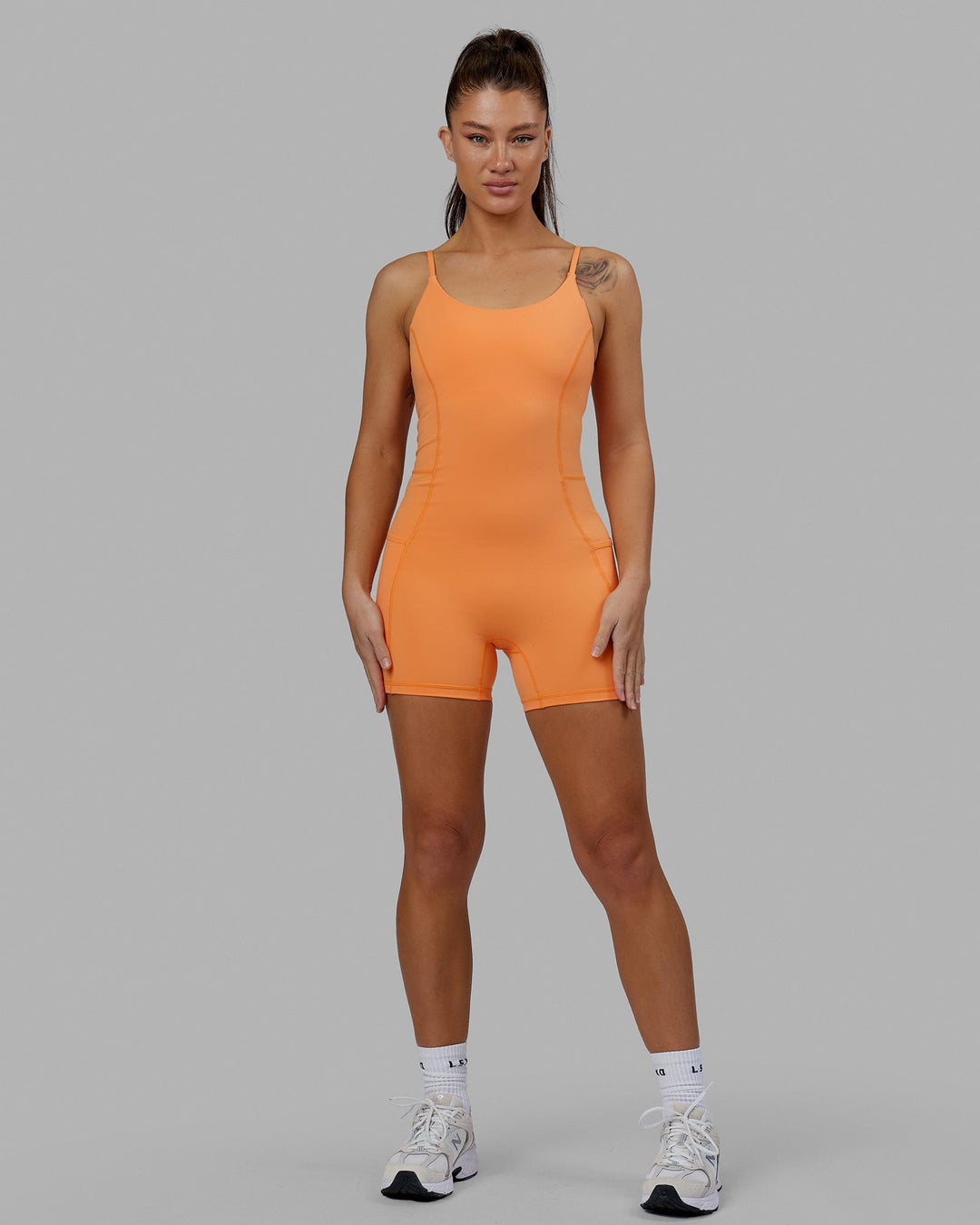 Woman wearing Helix Active Bodysuit - Tangerine
