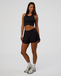 Woman wearing Hybrid Performance Crossover Tank - Black | Model:Bianca | Size:S