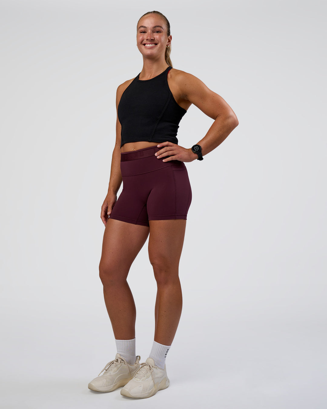 Woman wearing Ignite High Neck Tank - Black | Model:Sav | Size:S