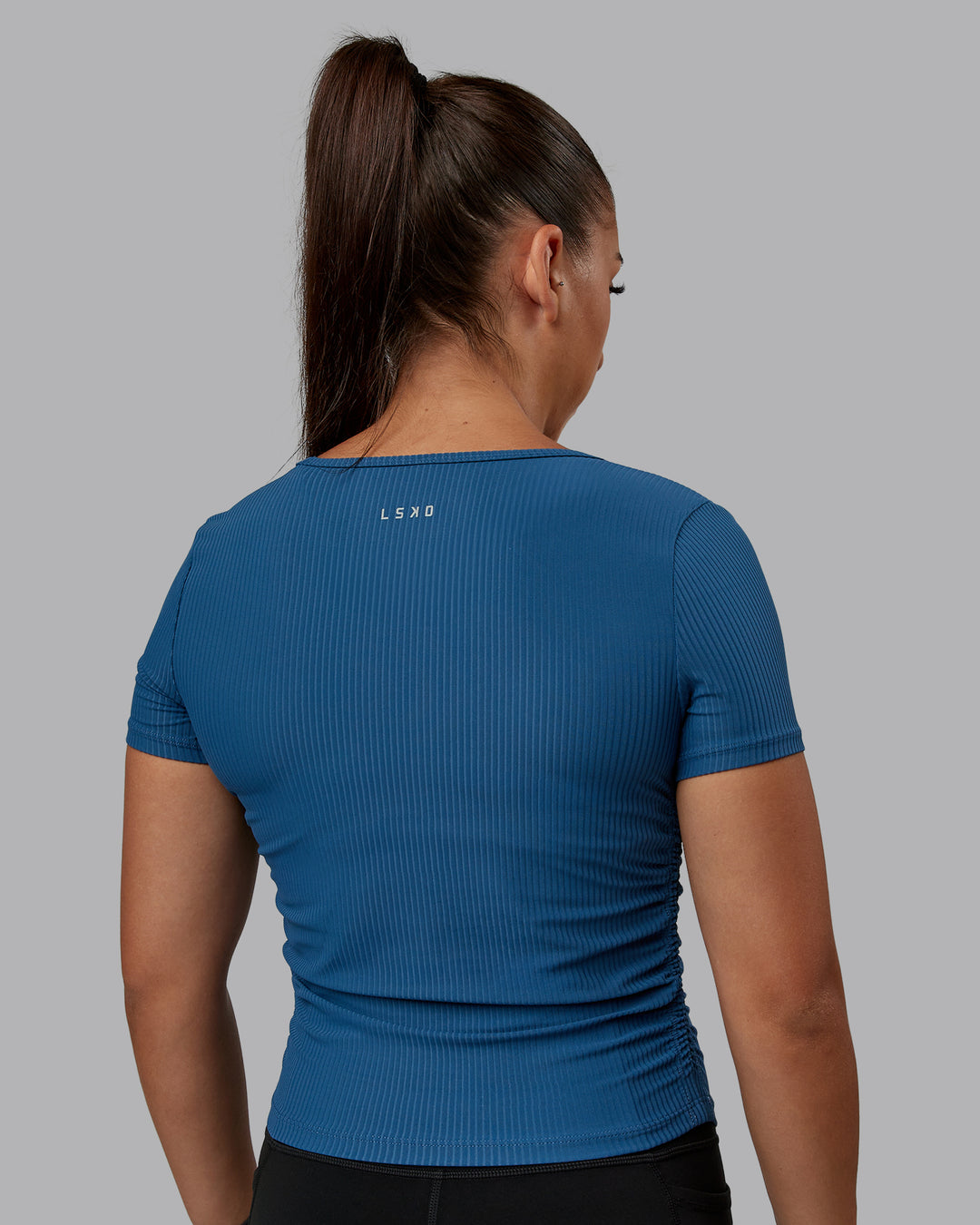 Woman wearing Ignite Ribbed Scrunch Side Cropped Tee - Indigo | Size:S | Model:Tylah