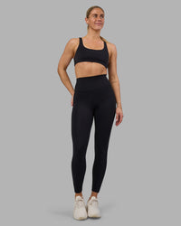 Woman wearing Impulse Reversible Sports Bra - Black | Model:Hannah | Size:S