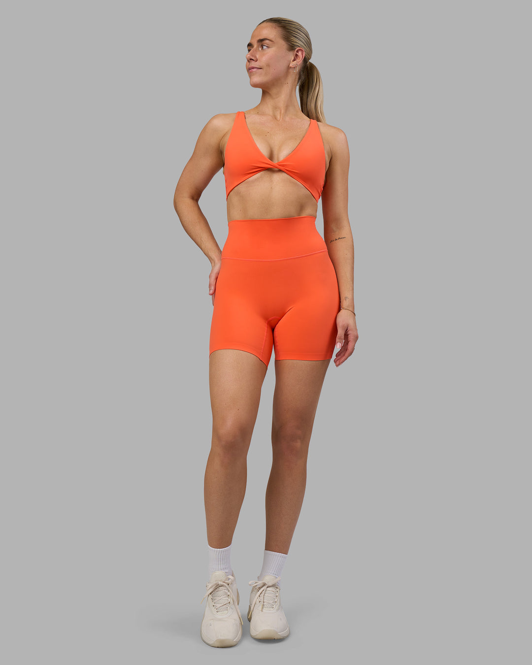 Woman wearing Impulse Reversible Sports Bra - Ultra Orange | Model:Hannah | Size:S