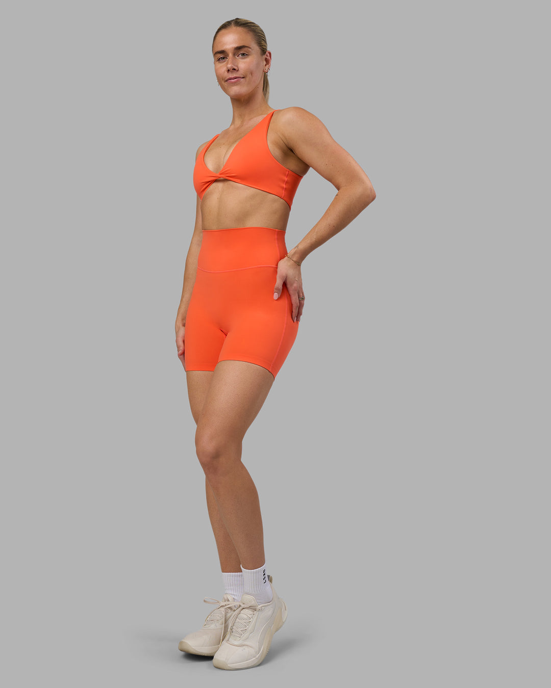 Woman wearing Impulse Reversible Sports Bra - Ultra Orange | Model:Hannah | Size:S