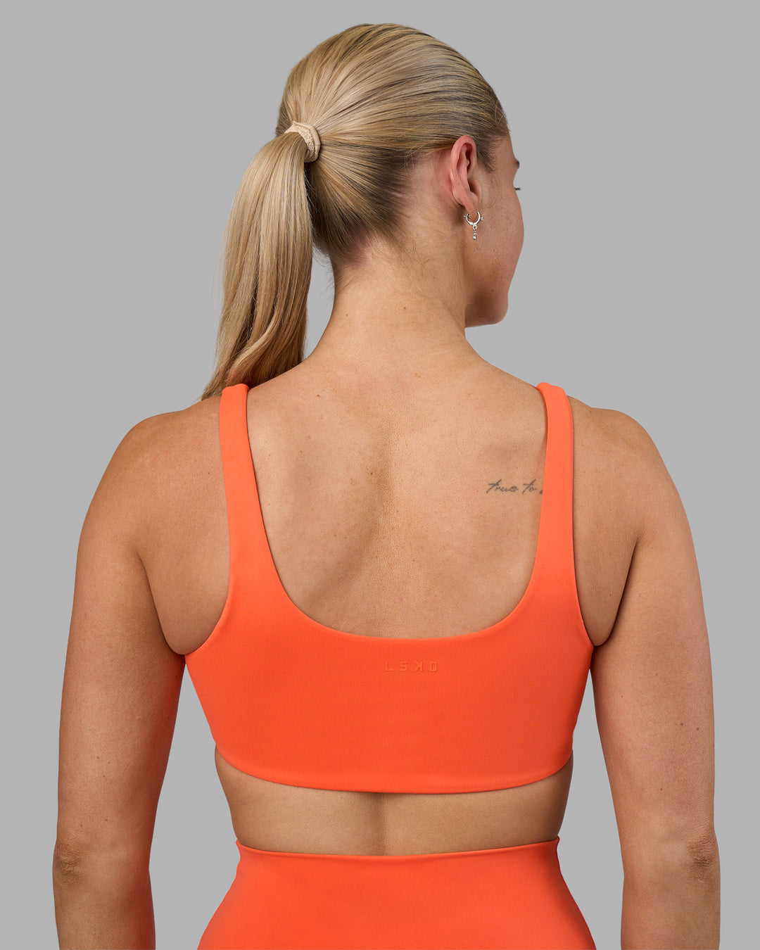 Woman wearing Impulse Reversible Sports Bra - Ultra Orange | Model:Hannah | Size:S