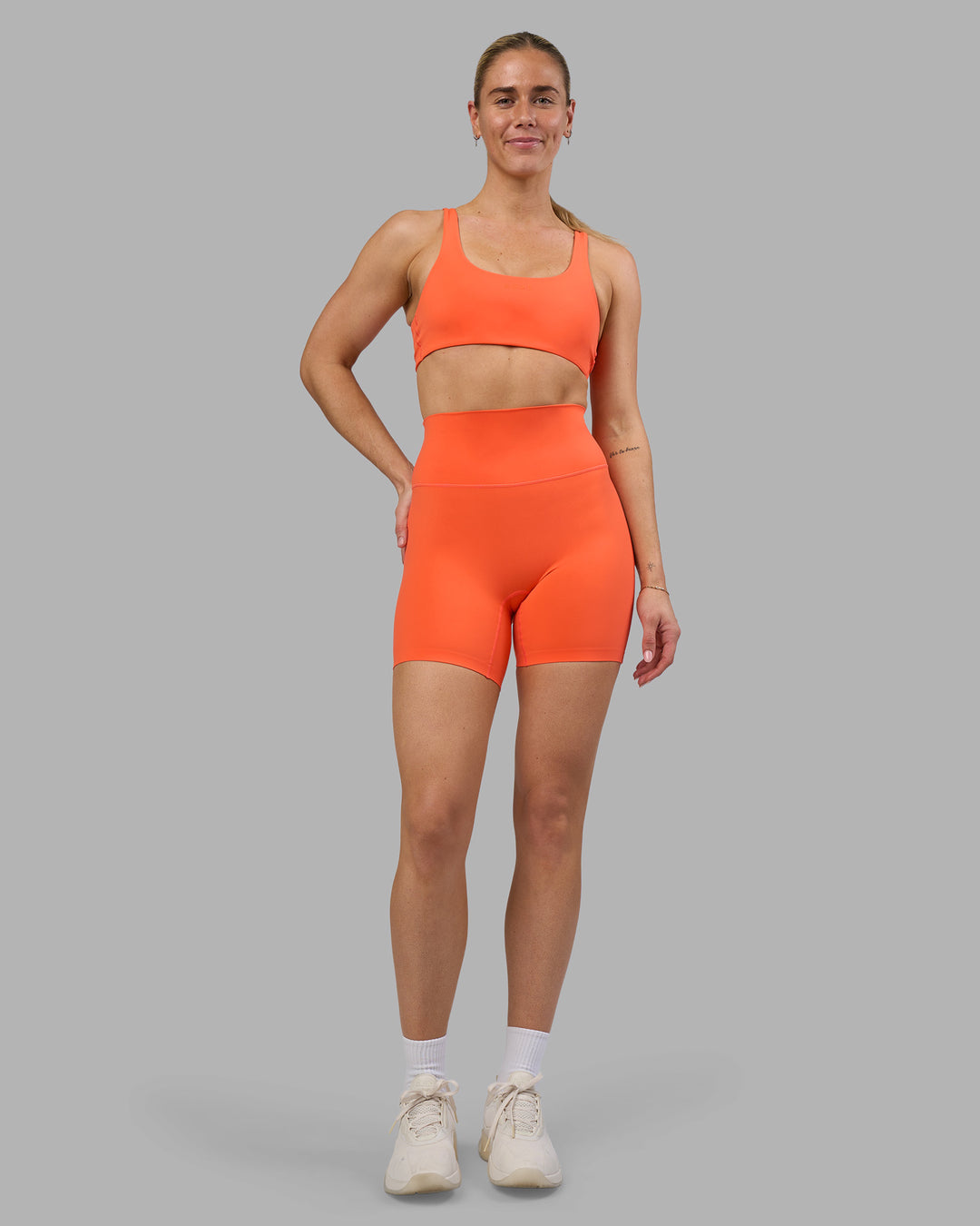 Woman wearing Impulse Reversible Sports Bra - Ultra Orange | Model:Hannah | Size:S
