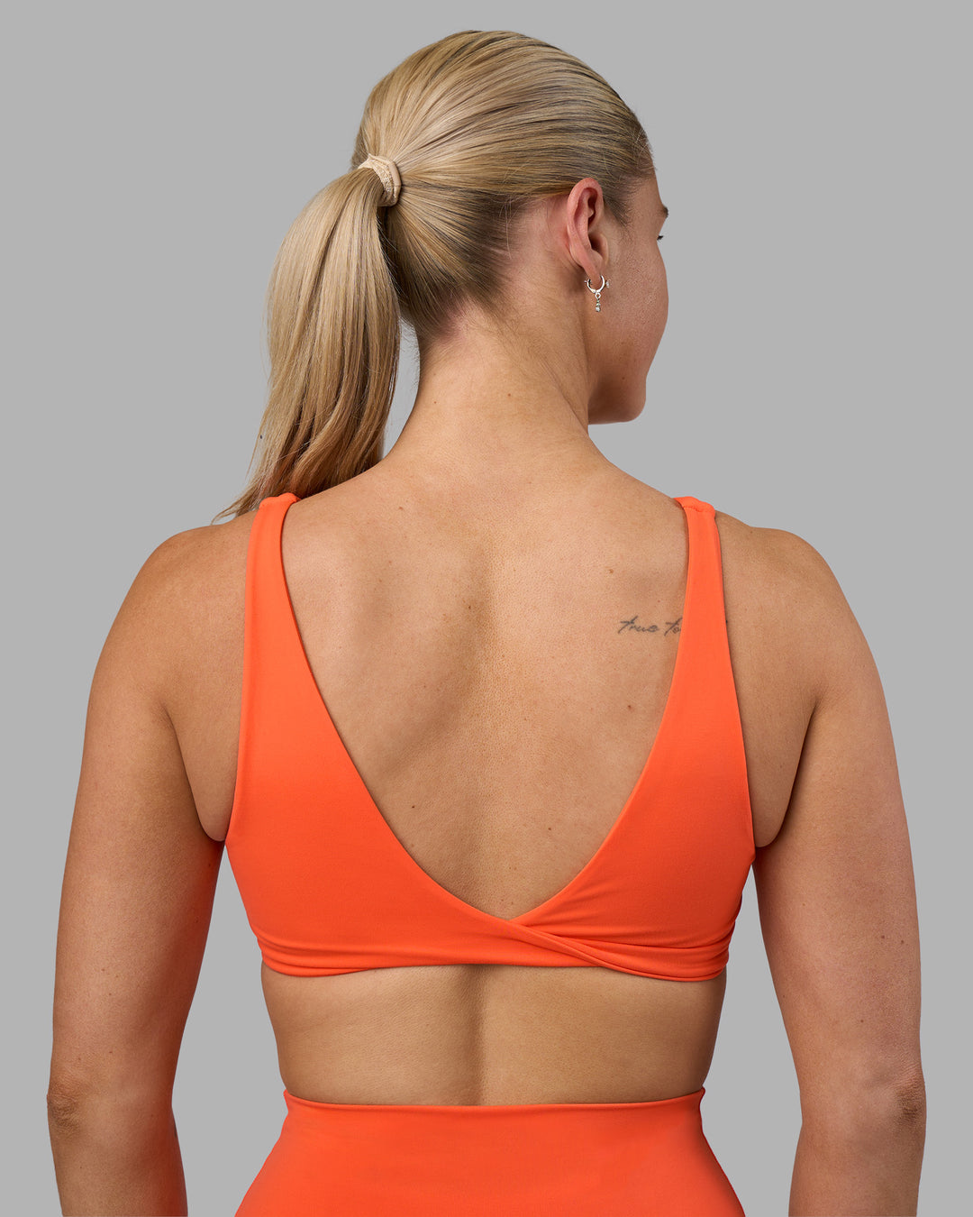 Woman wearing Impulse Reversible Sports Bra - Ultra Orange | Model:Hannah | Size:S